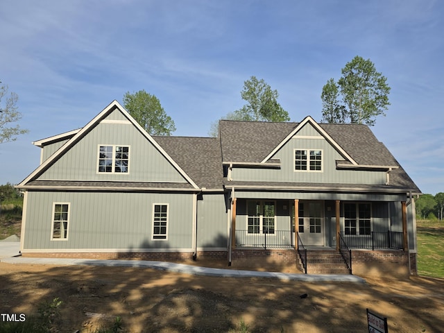 view of front of property featuring a porch and a shingled roof