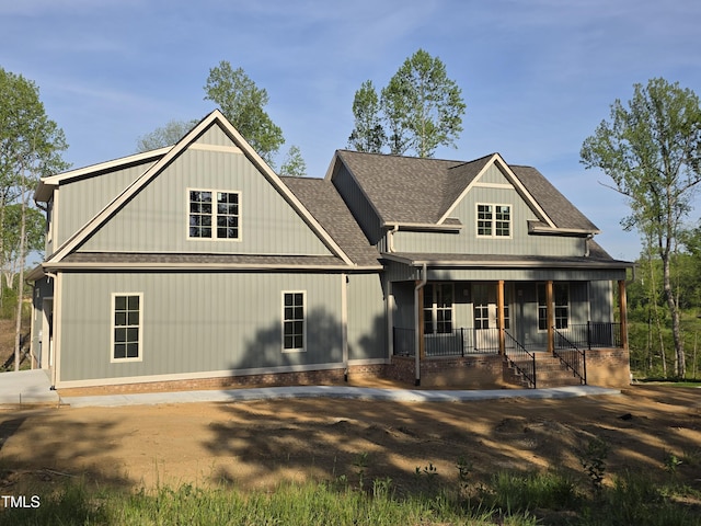 view of front facade with a porch and roof with shingles