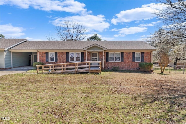 ranch-style home featuring driveway, a front yard, crawl space, a carport, and brick siding