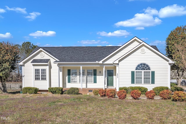 ranch-style house with a front yard, fence, roof with shingles, and crawl space