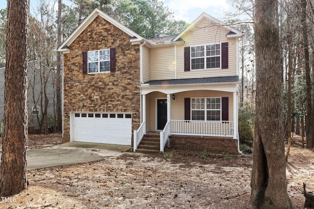 traditional-style home with a porch, stone siding, a garage, and driveway