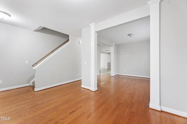 interior space with stairs, baseboards, and wood finished floors