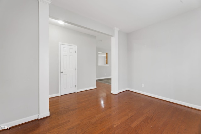 empty room featuring baseboards and wood finished floors