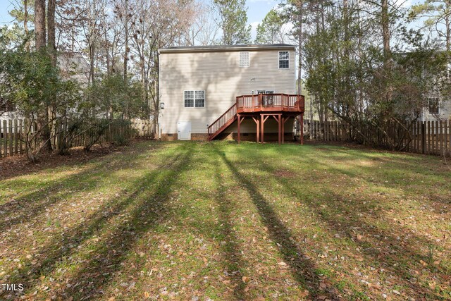 back of property with stairs, a lawn, a deck, a fenced backyard, and crawl space