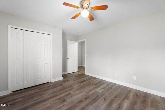 unfurnished bedroom with a closet, ceiling fan, baseboards, and wood finished floors