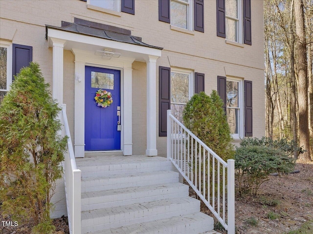 entrance to property with brick siding