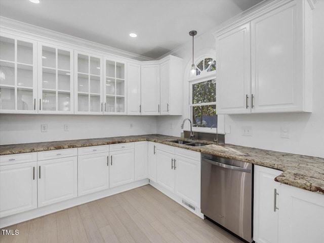 kitchen with a sink, dark stone countertops, stainless steel dishwasher, white cabinets, and glass insert cabinets