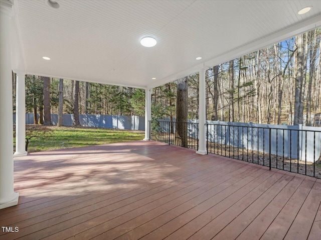 wooden deck featuring a lawn and fence