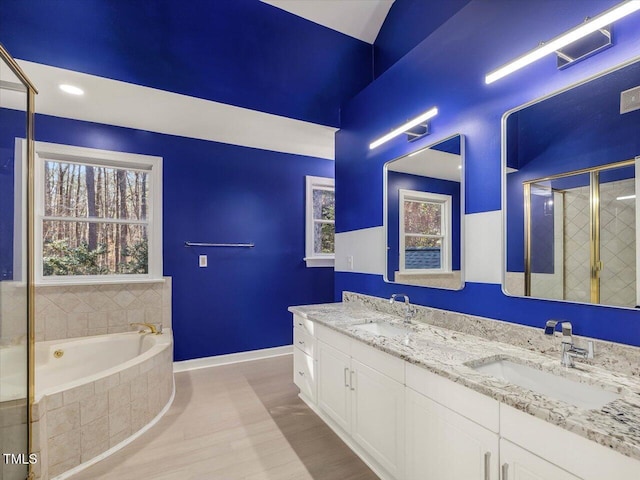 full bath featuring a garden tub, baseboards, a shower stall, and a sink