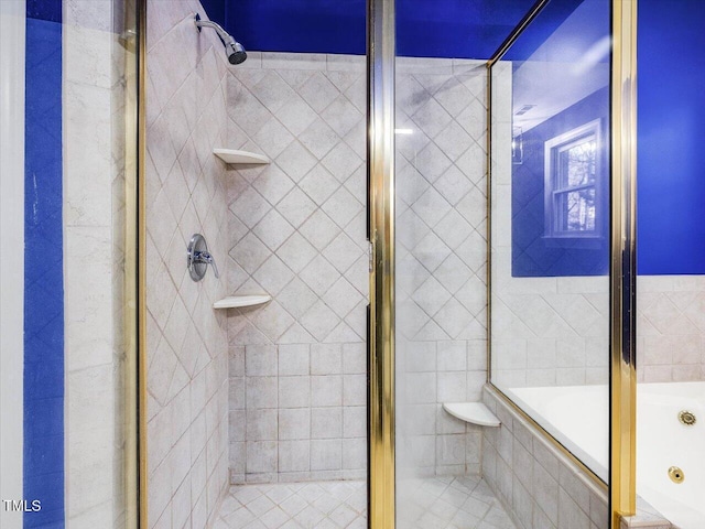 bathroom with a shower stall and tiled tub