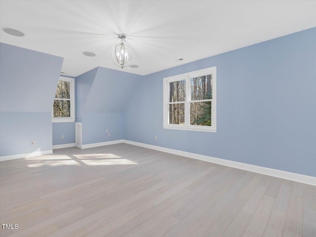 bonus room featuring visible vents, baseboards, and wood finished floors