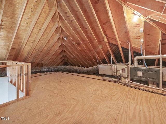 unfinished attic with an upstairs landing