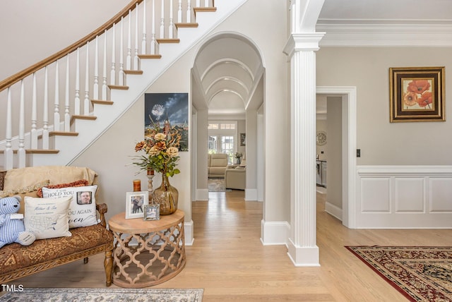 12500 Richmond Run Dr, Raleigh, NC 27614 - entrance foyer featuring decorative columns, light wood-style floors, crown molding, stairs, and baseboards