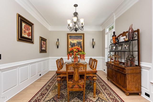 12500 Richmond Run Dr, Raleigh, NC 27614 - dining room with a chandelier, light wood-style flooring, crown molding, a decorative wall, and wainscoting