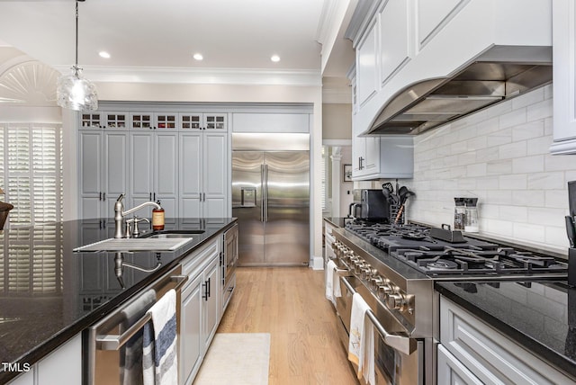 12500 Richmond Run Dr, Raleigh, NC 27614 - kitchen with built in appliances, crown molding, under cabinet range hood, glass insert cabinets, and backsplash