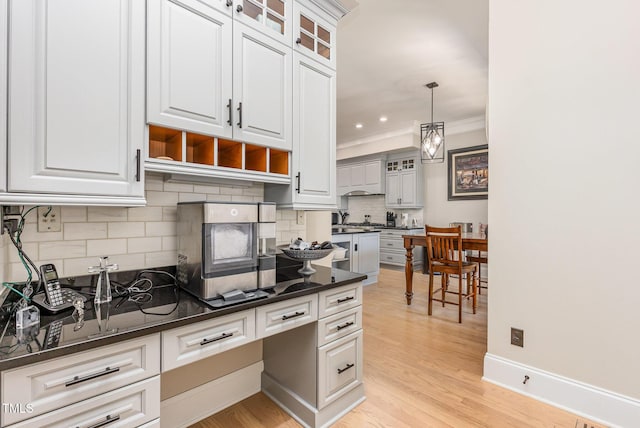 12500 Richmond Run Dr, Raleigh, NC 27614 - kitchen with decorative backsplash, ornamental molding, light wood-style floors, white cabinetry, and glass insert cabinets