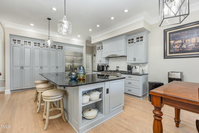 12500 Richmond Run Dr, Raleigh, NC 27614 - kitchen with built in refrigerator, dark countertops, open shelves, ornamental molding, and a center island with sink