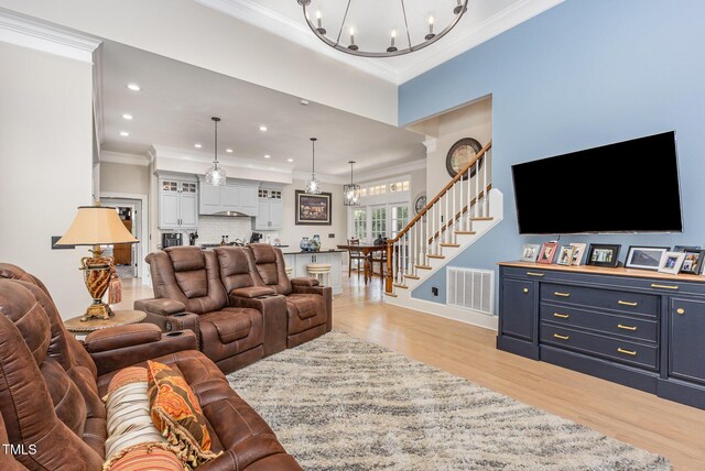 12500 Richmond Run Dr, Raleigh, NC 27614 - living area featuring a chandelier, light wood-style floors, stairs, ornamental molding, and recessed lighting