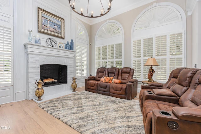 12500 Richmond Run Dr, Raleigh, NC 27614 - living area featuring a chandelier, ornamental molding, wood finished floors, and a brick fireplace