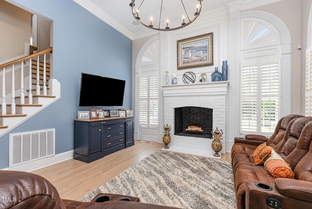 12500 Richmond Run Dr, Raleigh, NC 27614 - living room with stairway, a chandelier, ornamental molding, light wood-type flooring, and healthy amount of natural light