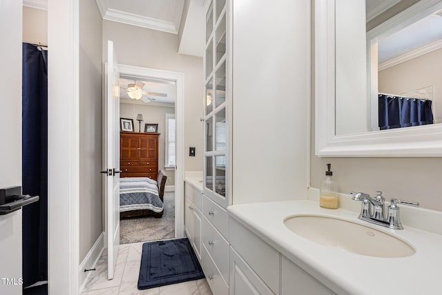 12500 Richmond Run Dr, Raleigh, NC 27614 - full bathroom with ornamental molding, vanity, ceiling fan, marble look tiles, and baseboards