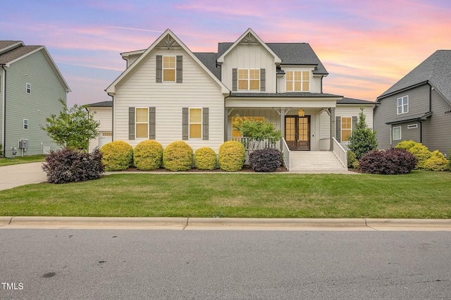 view of front of home with covered porch, board and batten siding, french doors, and a front yard