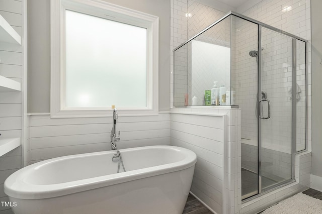 bathroom with a freestanding tub and a stall shower