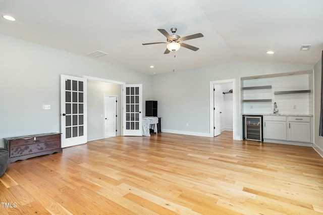 unfurnished living room with light wood-style flooring, recessed lighting, wine cooler, lofted ceiling, and ceiling fan