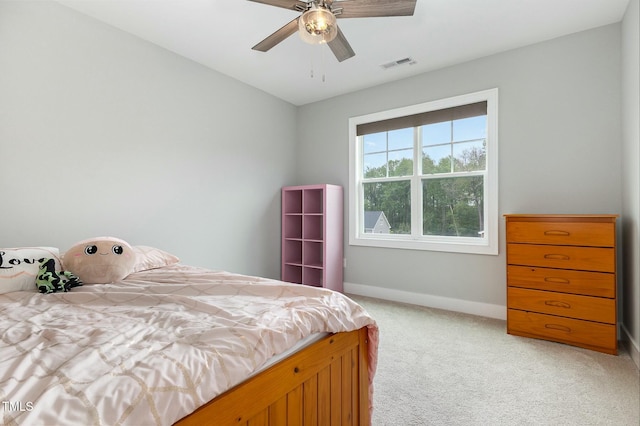 bedroom featuring ceiling fan, baseboards, visible vents, and light carpet