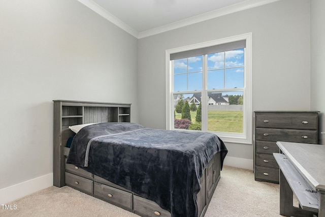 bedroom featuring light colored carpet, baseboards, and ornamental molding