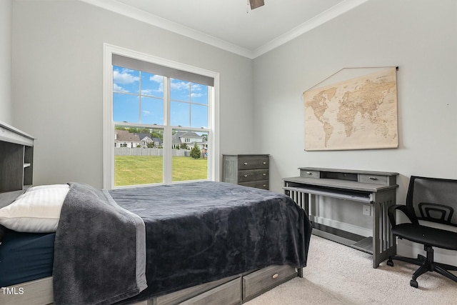 bedroom with crown molding, baseboards, and carpet floors