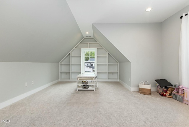 additional living space featuring lofted ceiling, built in features, baseboards, and carpet floors