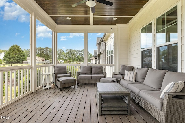 wooden deck with an outdoor hangout area and a ceiling fan