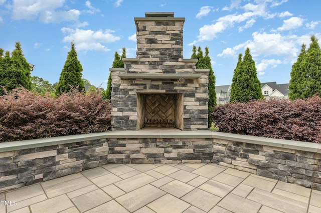 view of patio / terrace featuring an outdoor stone fireplace