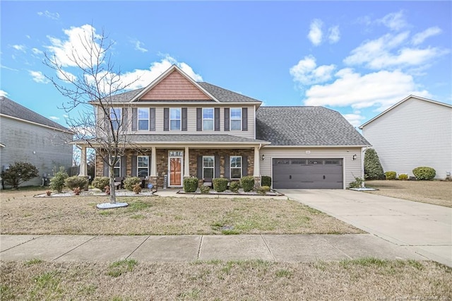 view of front of house with an attached garage, a porch, roof with shingles, a front yard, and driveway