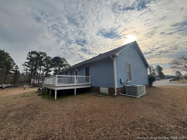 view of property exterior featuring a wooden deck and central AC unit