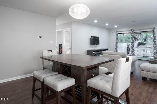 dining room featuring an inviting chandelier, recessed lighting, baseboards, and dark wood-type flooring