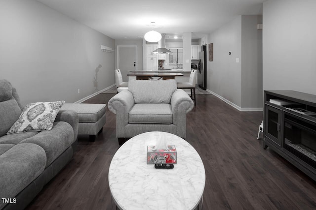 living room with dark wood finished floors and baseboards