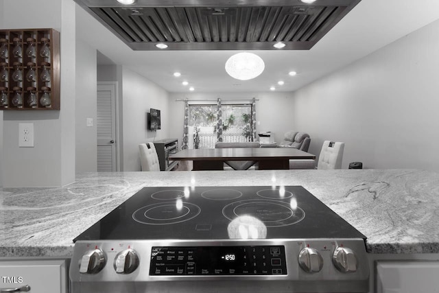 details with wall chimney range hood, light stone counters, stainless steel electric range, and recessed lighting