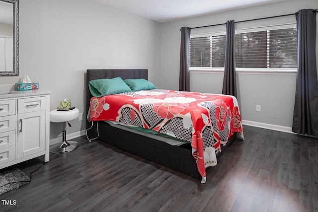 bedroom with dark wood finished floors and baseboards