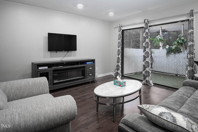 living room featuring baseboards and wood finished floors