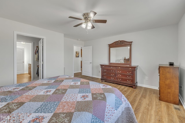 bedroom with ceiling fan, baseboards, and wood finished floors