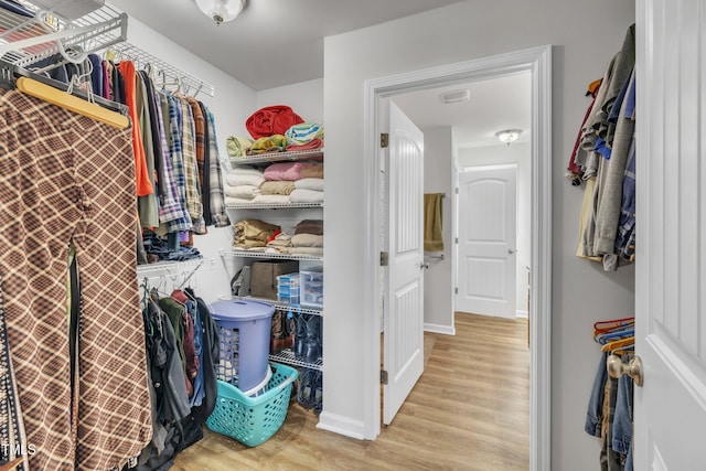 walk in closet featuring visible vents and wood finished floors