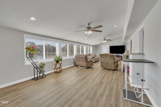 living area featuring recessed lighting, baseboards, vaulted ceiling, and light wood finished floors