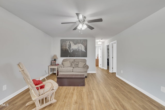 sitting room with wood finished floors, baseboards, and ceiling fan