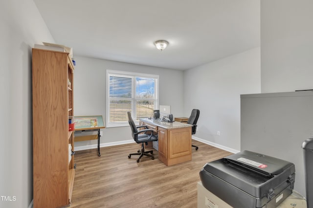 office area with light wood finished floors and baseboards