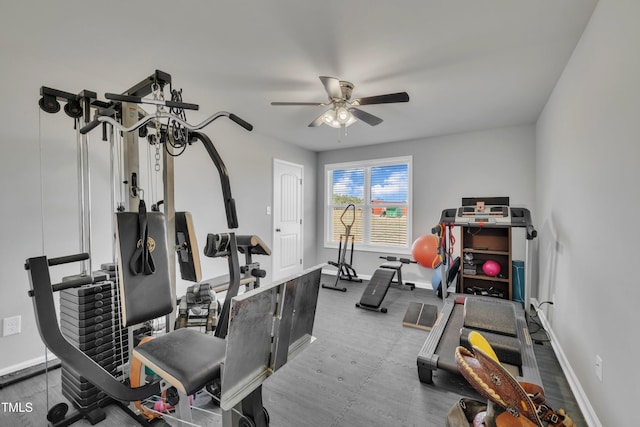 workout area with baseboards and a ceiling fan