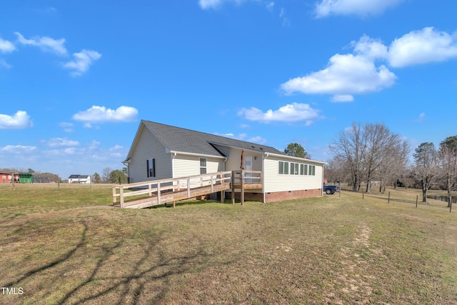 rear view of property featuring a wooden deck, a yard, fence, and crawl space