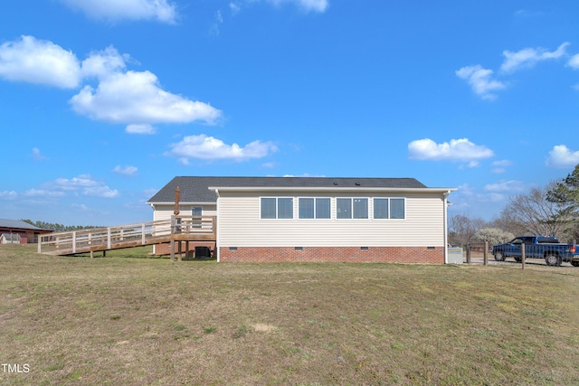 rear view of property featuring crawl space, a yard, and fence