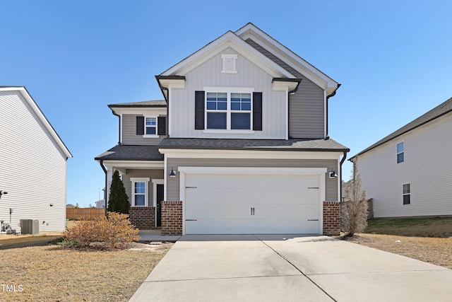 view of front facade with a garage, brick siding, board and batten siding, and driveway